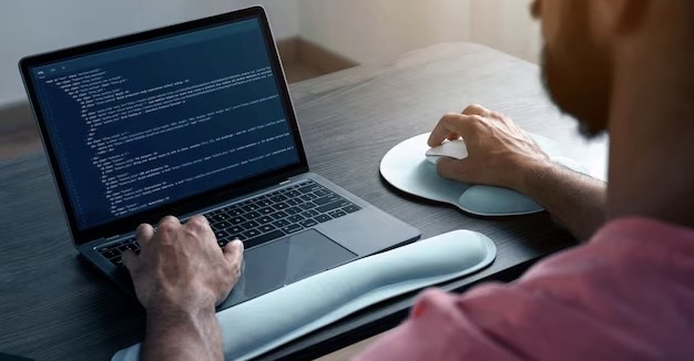 A man writes program code on a computer