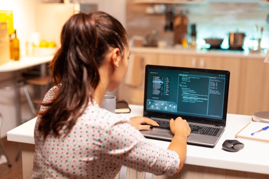 Woman working with code on computer