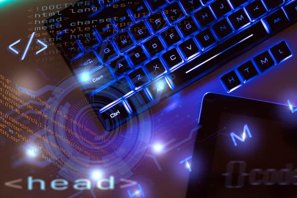 a tablet and keyboard on the table with blue neon backlight